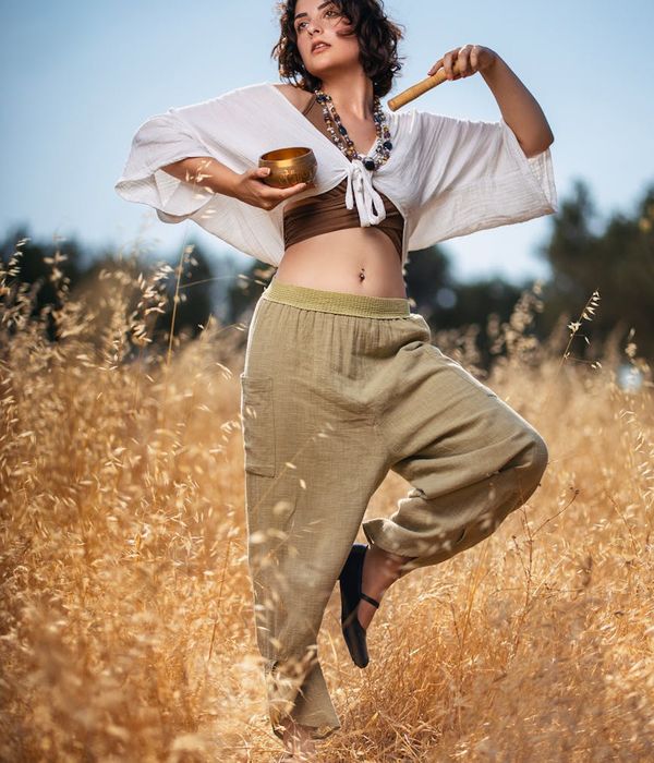 Woman in a calm yoga pose in a bright, serene environment.