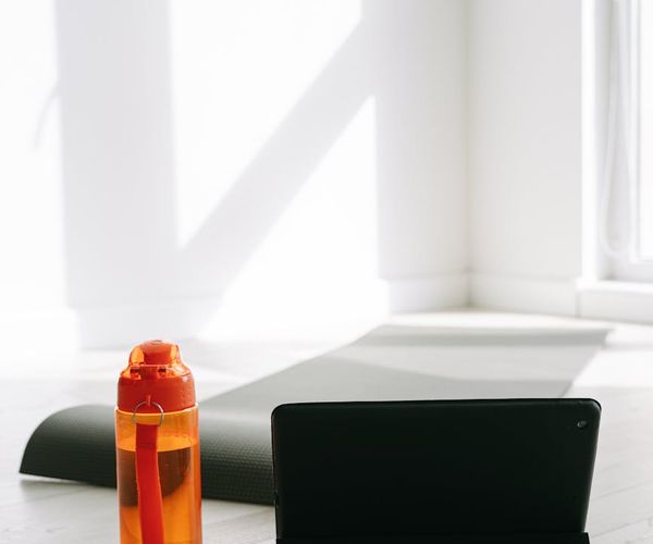 Yoga mat, water bottle, and a towel neatly arranged on the floor.